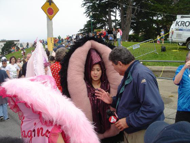 a photo of a man interviewing people dressed in vagina costumes