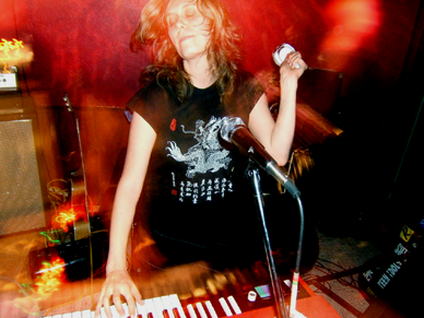 a photo of Krista Bones of Raised by Wolves playing the organ at the Candy Bar