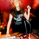 a photo of Krista Bones of Raised by Wolves playing the organ at the Candy Bar